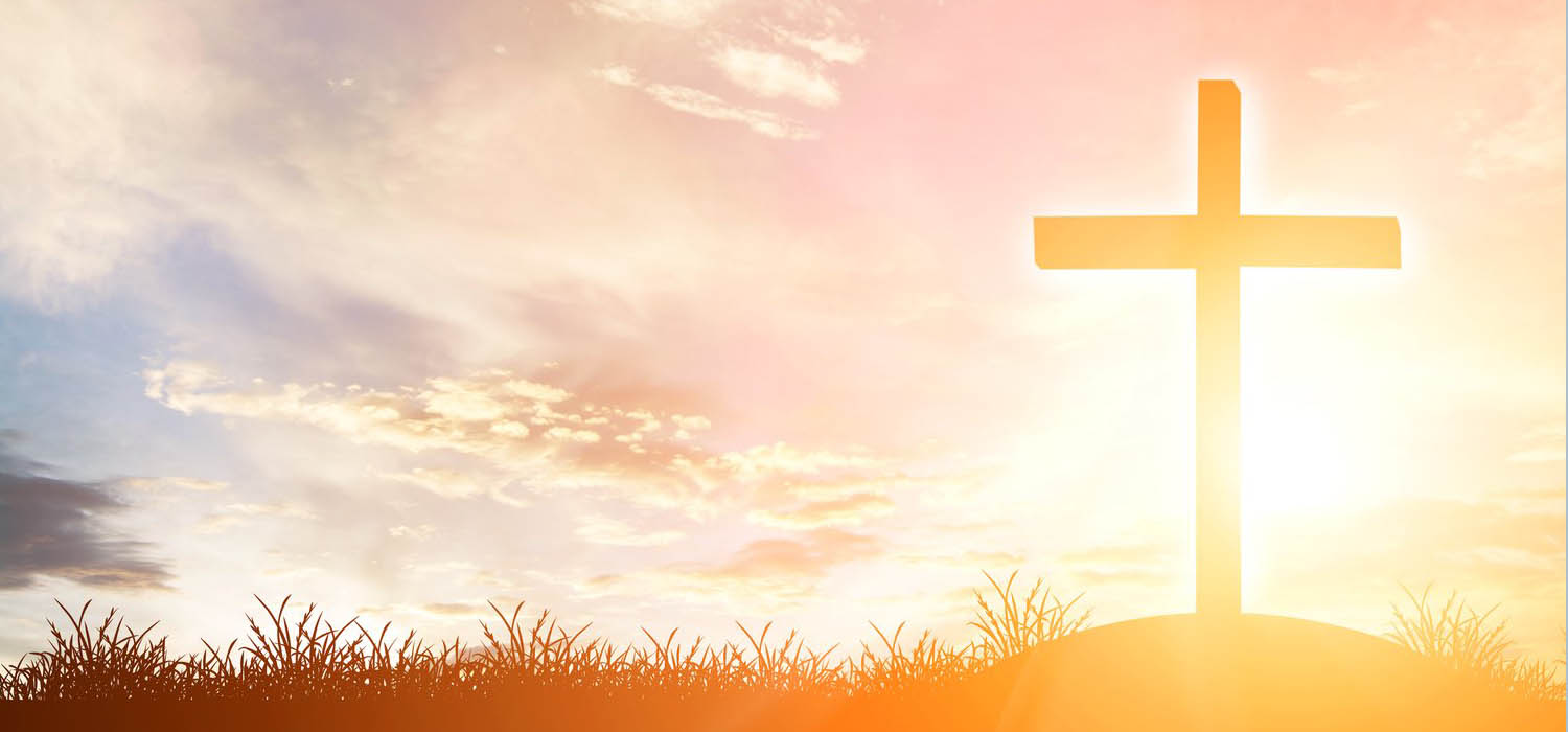 cross silhouette on the mountain at sunset